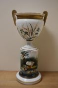 A late 19th Century aesthetic period opaque glass jardiniere and stand, the design depicting birds