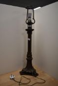 A vintage metal bronze effect column table lamp with acanthus leaf decoration and draping effect