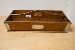 A late 19th/early 20th Century oak cutlery tray with two divisions and applied white metal mounts,