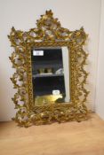 A 20th Century gilt metal wall mirror of rectangular form and Italian in style, measuring 30cm x