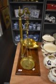 A set of late 19th/early 20th century brass scale with mahogany base.