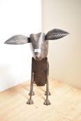 A 20th Century rustic metal garden ornament modelled as a nodding dog, measuring 44cm tall