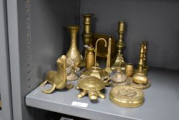 An assorted collection of brassware, including candlesticks, an obelisk ring holder, and various