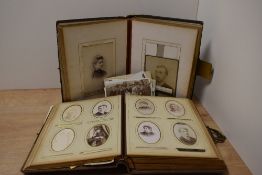 A Victorian leather carte de visite photograph album with photographs, measuring 20cm x 28cm, and