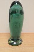 A Victorian bottle green glass dump paperweight, of elongated form with internal suspended