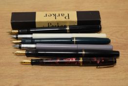 A selection of six Parker pens including a boxed Parker Victory in black, a Parker Junior Duofold in