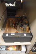 An assortment of pharmaceutical bottles and vials, approximately 18.