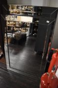 A contemporary rectangular mirror with bevelled glass frame, measuring 74cm x 106cm
