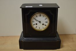 A Victorian slate mantel clock of architectural form, having an enamelled Roman dial with two