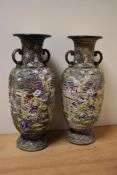 A pair of 20th Century Japanese enamelled vases of urn form, decorated with bands of figures and