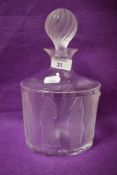 A 20th Century Lalique glass decanter and stopper decorated in the 'Femmes' pattern, the design on