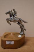An early 20th Century Desmo chrome mascot modelled as a horse and jockey, mounted on an oak base,