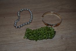 A selection of bracelets comprising a silver beaded example, a Chinese style expanding bracelet with