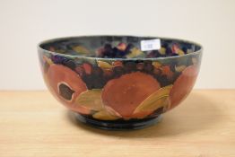 A Moorcroft Pottery fruit bowl, having tube lined grape and pomegranate design on cobalt blue
