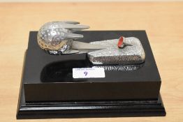 *Golfing interest - A 20th Century chrome metal mascot of a golf ball and tee, mounted on a