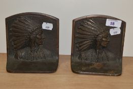 A pair of 20th Century cast metal bookends decorated with an Indian Chief in profile, each measuring