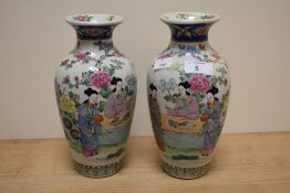 A pair of late 19th/early 20th Century Japanese vases, of baluster form and decorated in