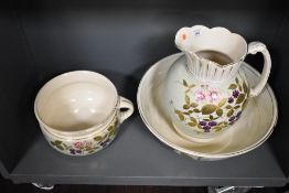 A late 19th Century toilet jug, bowl, and chamber pot, of Aesthetic Period design featuring floral