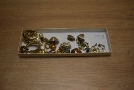 An assortment of clip-on earrings, including a silver and pearl drop pair, a pear-shaped shell pair,