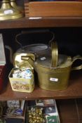 A large unlidded copper kettle, a brass watering can in the style of Dr Christopher Dresser, and a