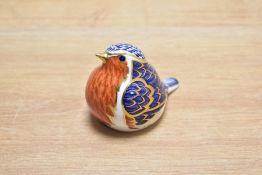 A Royal Crown Derby bone china Robin paperweight, decorated in the Imari palette with gold
