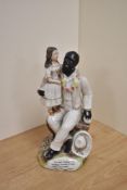 A 19th century Staffordshire pottery figure group 'Tom and Eva' the base with transferred