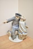 A large Nao porcelain figure group 'Waiting Time for the Fisherman' modelled as an young child and