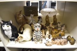 A collection of various decorative cat studies, to include an attractive carved and painted wood