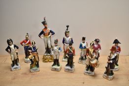 Two Capo-di-Monte porcelain 19th century soldier figures, British Hussars officer standing on a gilt