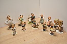 A group of ten Goebel porcelain 'Hummel' figures and figurines, to include 'The Photographer' (