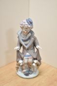 A Lladro porcelain clown group 'Suprise' number 5091, modelled as a forlorn clown revealing a dog