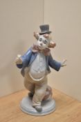 A Lladro porcelain clown figure 'For a Smile' number 6937, modelled as a clown offering a flower,