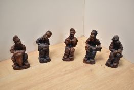 An interesting group of five African terracotta musician figures, each modelled seated hoding