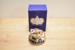 A Royal Crown Derby bone china frog paperweight, decorated in a stylised Imari palette with gold