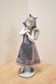 A Lladro porcelain figurine 'Nature's Bounty' modelled as a young Dutch girl with flower basket,