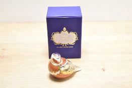 A Royal Crown Derby bone china chaffinch paperweight, decorated in a stylised Imari palette with