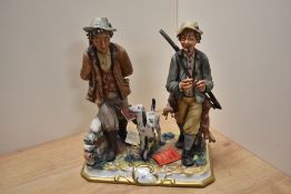 A CapoDiMonte Porcelain game hunting figure group, two hunters walking and their gun dog companion