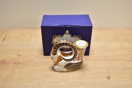 A Royal Crown Derby bone china goat candleholder, decorated in a stylised Imari palette with printed