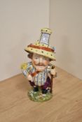 An early 19th century Derby porcelain mansion house dwarf, modelled dressed in opulent attire
