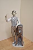 A Lladro porcelain 'Say Cheese' Photographer figure, 5195 modelled standing next to his camera