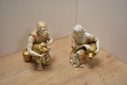 A pair of early 20th century Royal Worcester bone china 'blush ivory' kneeling Eastern water carrier