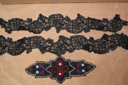 An Art Deco beaded applique and a two piece garter set