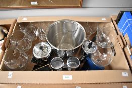 A good selection of assorted wine glasses and champagne flutes, a plated ice bucket, a Swan