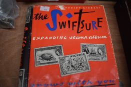 A Stanley Gibbons 'The Swiftsure expanding stamp album', housing a a variety of stamps.