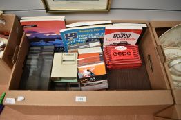 A box of various slides, slide viewer, screen pointer and photography books