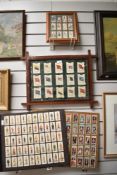 An assorted collection of cigarette cards to include two framed collections depicting Monarchs of