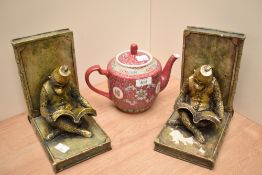 A pair of resin moulded bookends, in the form of Bellhop Reading Monkeys wearing Fez hats, each