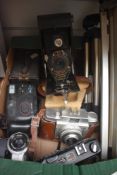 A selection of cameras. A Kodak 2A folding camera, a Kodak Brownie No2 Brownie, a Yashica MG-1, an
