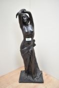 An Art Nouveau style cast-resin depiction of a semi nude maiden with arms held aloft AF damage to