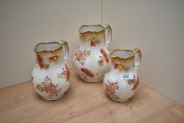 A trio of Royal stafforshire semi porcelain 'Scarbro' graduated jugs, having white ground with